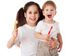 Girl teaches boy brushing the teeth