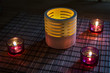 tea candles in wood and glass standing on reed mat
