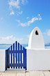 Traditional greek gate and chimney overlooking the caldera in Oi