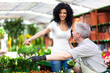 Female customer choosing flowers in a greenhouse