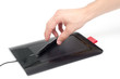 A hand reaching for a tablet