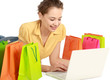 Photo: Young girl lying on the floor with laptop near shopping bag Young girl lying on the floor with laptop near shopping bag