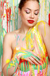 Photo: Beautiful woman painted with many vivid colors. Beautiful woman painted with many vivid colors.