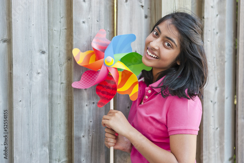 Photo: teenage girl with pinwheel teenage girl with pinwheel