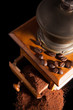 Old vintage coffe mill with ground coffee.