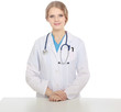 Foto: Young doctor woman with stethoscope standing near table Young doctor woman with stethoscope standing near table