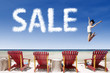 Advertising sale jump over beach chairs