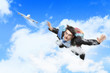 Young businessman flying with parachute on back