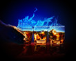 Three glasses of burning yellow absinthe