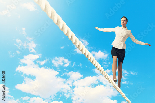Photo: Businesswoman balancing on rope Businesswoman balancing on rope