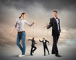 Businesspeople with marionettes