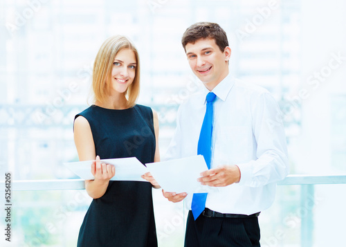 Photo: Two young business collegues. Two young business collegues.