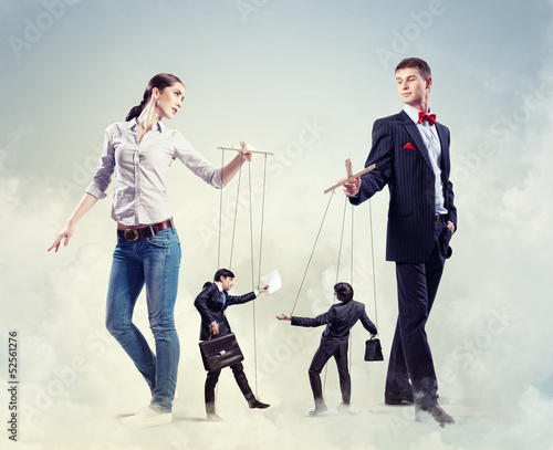 Photo: Businesspeople with marionettes Businesspeople with marionettes