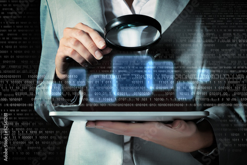 Photo: Businesswoman with magnifier glass Businesswoman with magnifier glass