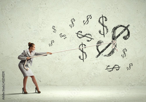 Photo: Businesswoman pulling rope Businesswoman pulling rope