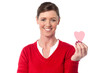 Woman showing cute paper heart to camera