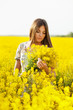Girl holding a bouquet of yellow flowers
