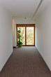 Corridor with wooden window at the end
