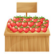 A strawberry stand with an empty wooden signboard