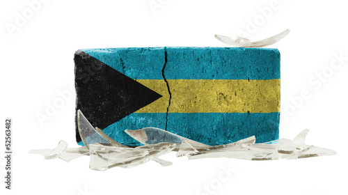 Photo: Brick with broken glass, violence concept Brick with broken glass, violence concept