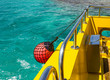 Part of fishing boat with red buoy