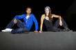 free runner scaling or climbing a wall at night to do parkour
