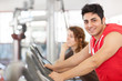 Photo: Man is doing workout on a bicycle at the gym Man is doing workout on a bicycle at the gym