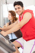 Photo: Man is doing workout on a bicycle at the gym Man is doing workout on a bicycle at the gym