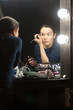 Foto: Woman applying makeup Woman applying makeup