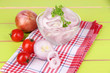 Onion cut with rings in bowl on wooden table close-up