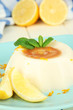 Lemon Panna Cotta with orange zest and caramel sauce,