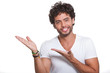 Young man by pointing with both hands