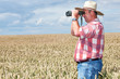 Man with binoculars in cornfield