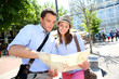 Couple in Santa Ana square of Madrid reading city map