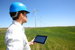 Businessman checking on wind turbine energy production