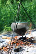 Camping kettle over burning campfire