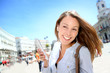 Photo: Cheerful girl using smartphone in town Cheerful girl using smartphone in town