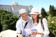 Couple reading traveler book by the Royal Palace of Madrid