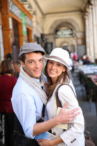 Photo: In love couple walking in the street of Madrid, Spain In love couple walking in the street of Madrid, Spain