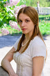 Beautiful girl in a spring garden with a pearl necklace
