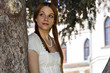 The girl in the fairy tale castle on the background of a pine tr