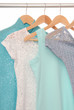 Summery blouses are on coat-hangers.