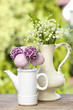 Lilly of the valley flowers and pastel cake pops on wooden table