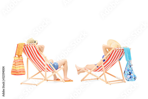 Photo: Couple relaxing on a sun loungers Couple relaxing on a sun loungers