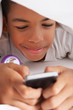 Boy Using Mobile Phone Under Duvet