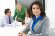 Portrait Of Businesswoman In Boardroom With Colleagues