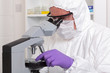 Lab technician adjusting microscope slide