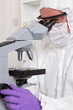 Lab technician focussing a microscope