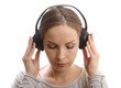 Young woman listening music with headphones, on white