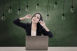 Photo: Businesswoman think under light bulbs Businesswoman think under light bulbs